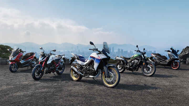 CMX1100 Rebel with rider and pillion on road at dusk